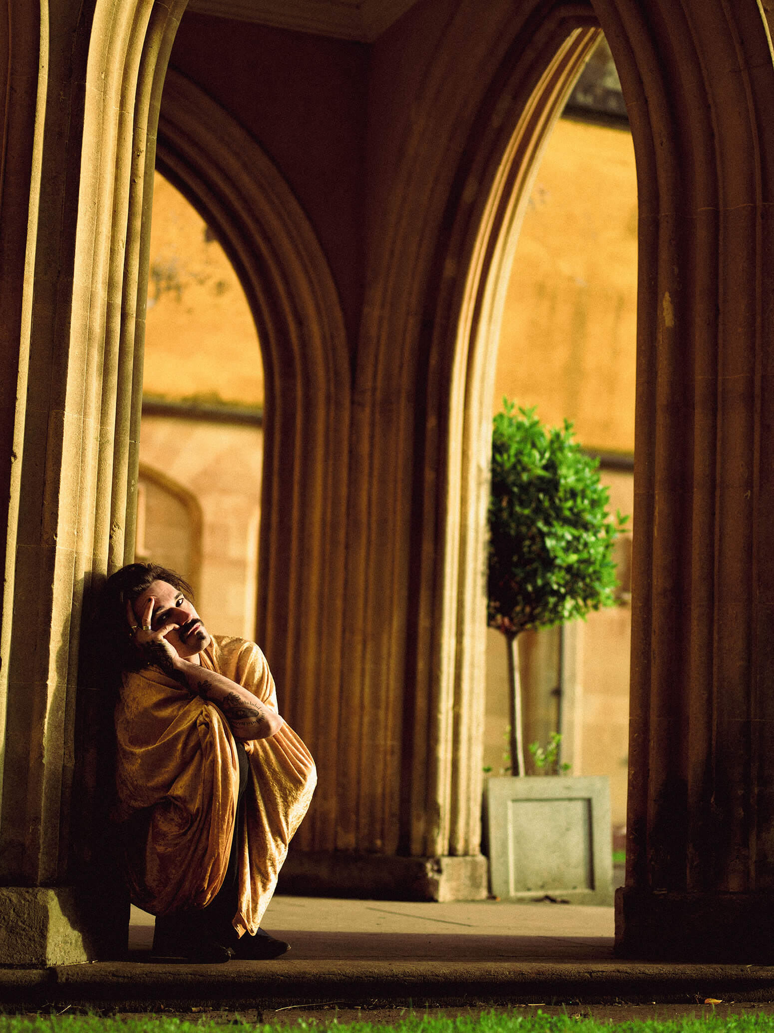Stanley Duke Crouched Down Wrapped in a Gold Blanket